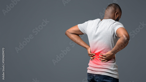 Slika na platnu Afro guy holding both hands on lower back, pain in spine, inflamed zone highligh