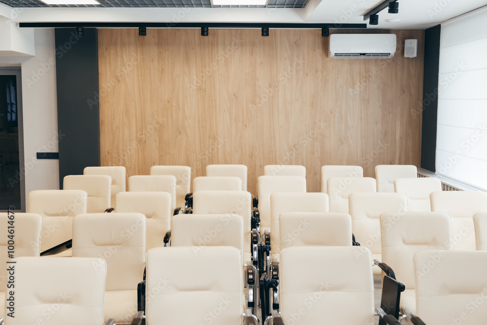Beige leather chairs in seminar room. Seats in an empty conference room Beige leather chairs in seminar room. Seats in an empty conference room