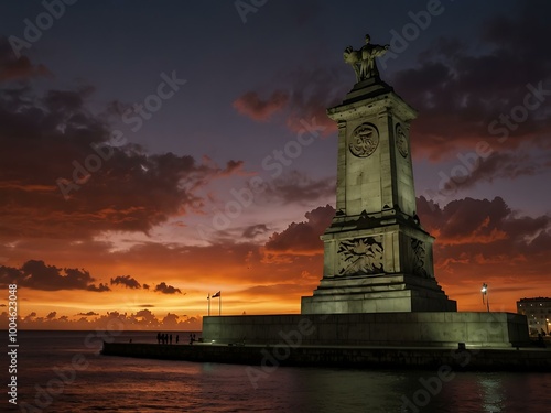 Burning skies illuminate the Antonio Maceo monument along the Malecon in Havana. photo