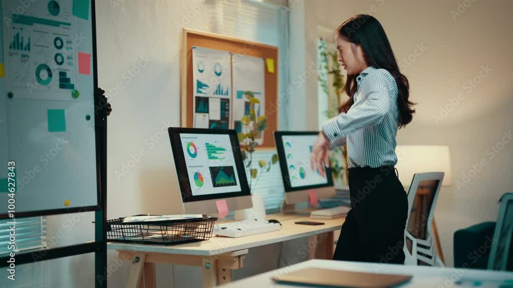 Businesswoman is analyzing company growth on a computer screen in her office. She is getting increasingly frustrated with the results Businesswoman is analyzing company growth on a computer screen in her office. She is getting increasingly frustrated with the results