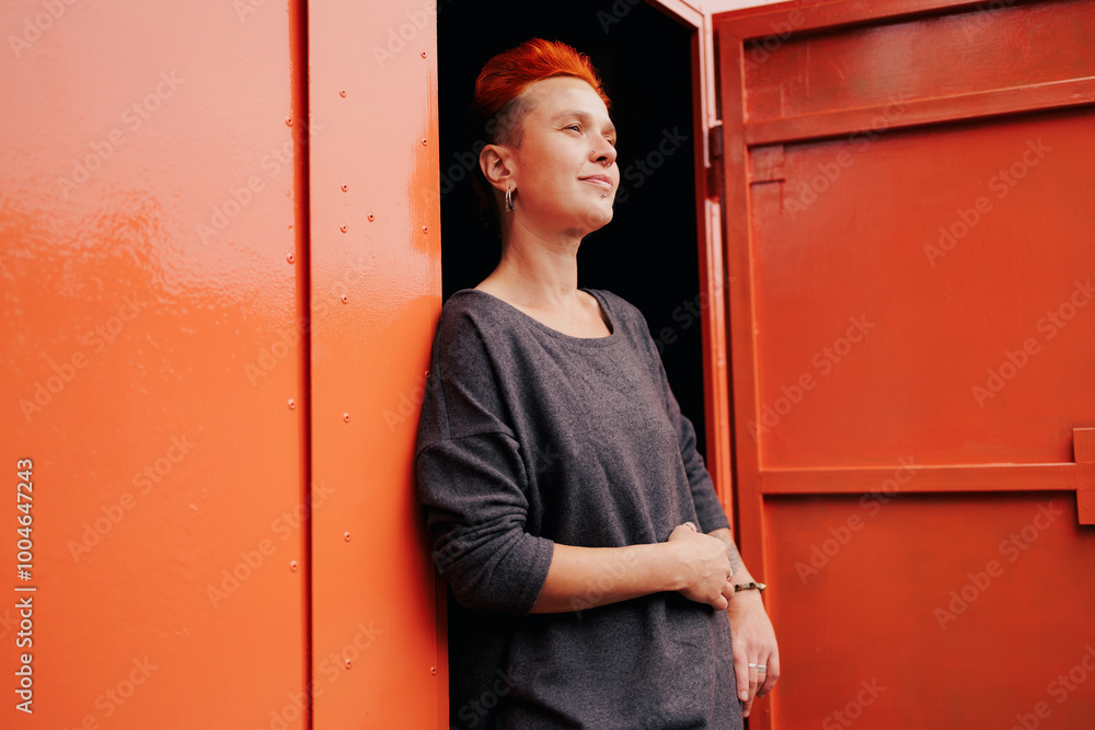 Woman with vivid hair standing near garage with open door outdoors Woman with vivid hair standing near garage with open door outdoors