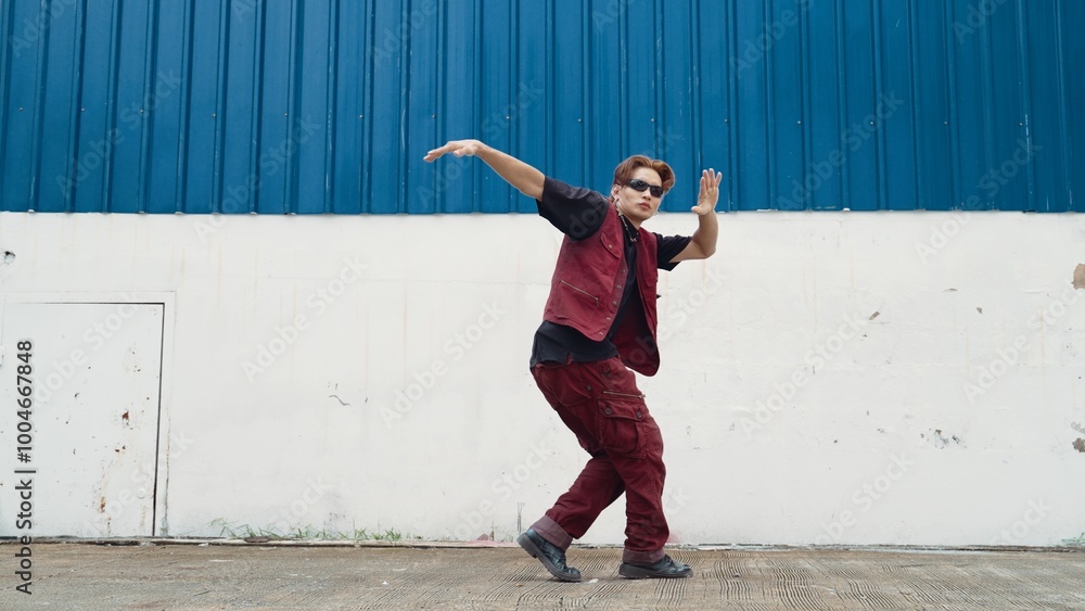 Handsome street dancer practicing break dancing at white back ground. Sport man wearing hip hop style while moving footsteps to music at street with blue background. Outdoor sport 2024. Hiphop. Handsome street dancer practicing break dancing at white back ground. Sport man wearing hip hop style while moving footsteps to music at street with blue background. Outdoor sport 2024. Hiphop.
