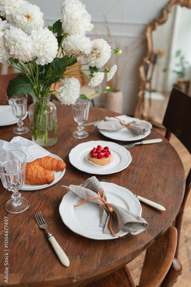 Fototapeta premium A beautifully set table in the living room for tea and dessert.