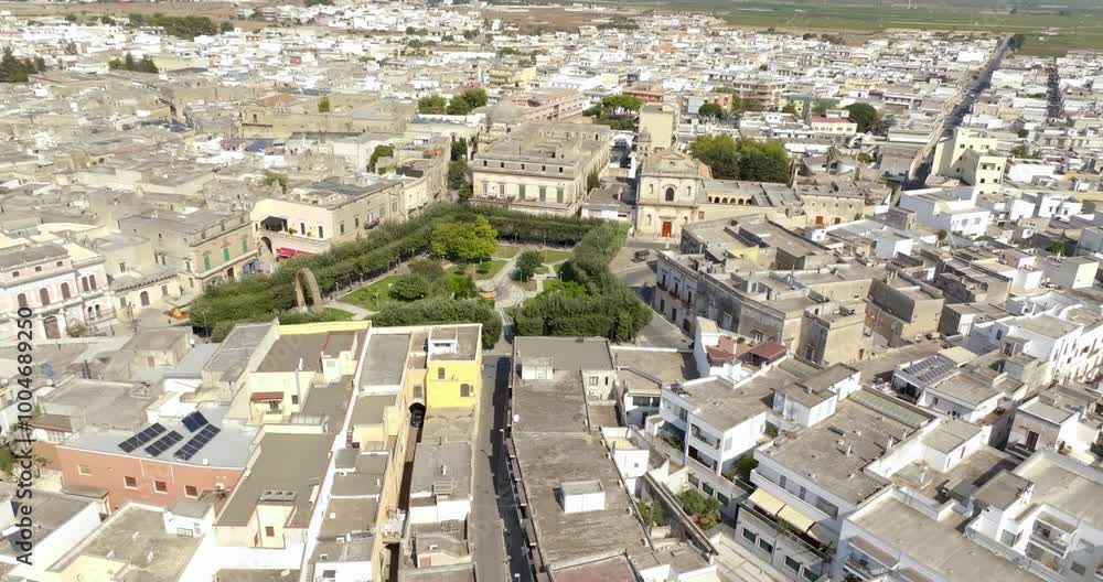 Aerial view of the Manduria municipal villa in the province of Taranto, Italy. In the public park there is a fountain and a war memorial. Aerial view of the Manduria municipal villa in the province of Taranto, Italy. In the public park there is a fountain and a war memorial.