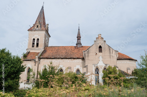 Enigmatic Ruins of a Once Majestic Church Surrounded by Nature's Embrace photo