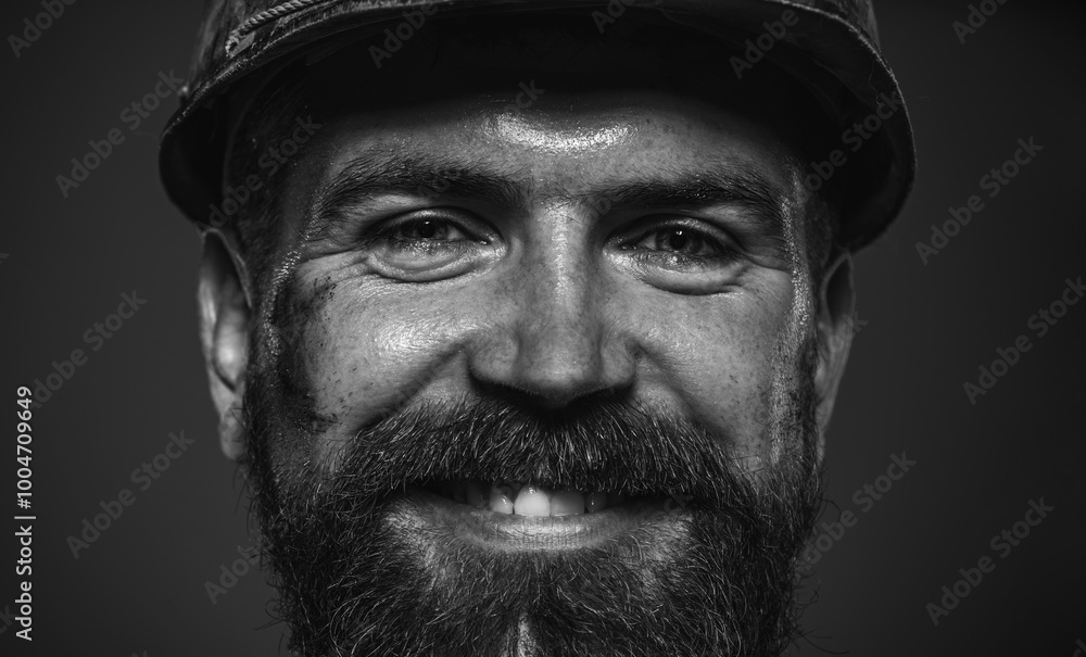 Closeup portrait of smiling construction worker, engineer or architect in safety helmet. Bearded mechanical or industrial worker in protective hardhat. Male builder in hard hat. Black and white. Closeup portrait of smiling construction worker, engineer or architect in safety helmet. Bearded mechanical or industrial worker in protective hardhat. Male builder in hard hat. Black and white.