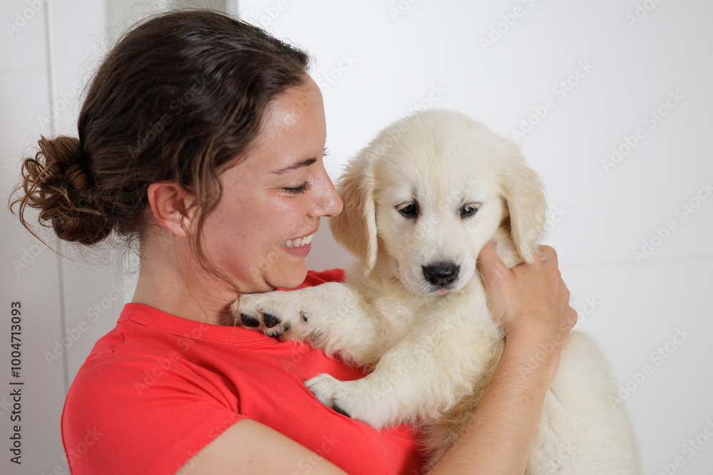 Portrait of a young woman with her golden retriever puppy. Family moments. Sharing time with loved ones. No to animal abandonment. Pets. The dog is man's best friend. Portrait of a young woman with her golden retriever puppy. Family moments. Sharing time with loved ones. No to animal abandonment. Pets. The dog is man's best friend.