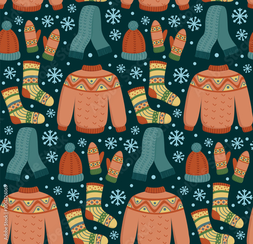 Seamless pattern with cute knitted winter clothes and snowflakes. Hand drawn background with woolen hat, scarf, sweater, mittens and socks on dark blue backdrop	