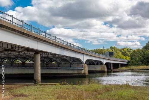 Motorway bridge in the UK, Image shows a bridge supporting the M27 over a river as traffic passes by on top on a cold Autumn day photo