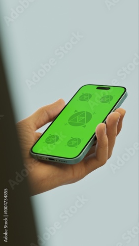 Wallpaper Mural Caucasian White middle aged male using smartphone with a blank green screen. Mobile app mockup. Vertical phone orientation Torontodigital.ca