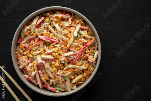 Homemade Japanese Kani Salad with Crab Sticks and Vegetables on a Plate, top view.