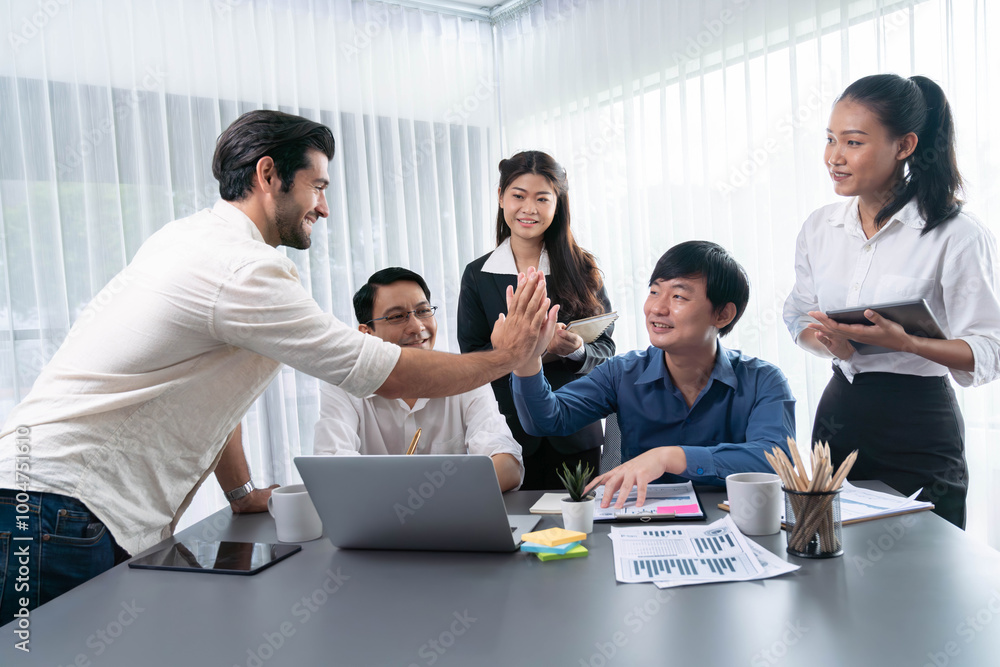Diverse group of office employee worker high five after making agreement on strategic business marketing planning. Teamwork and positive attitude create productive and supportive workplace. Prudent Diverse group of office employee worker high five after making agreement on strategic business marketing planning. Teamwork and positive attitude create productive and supportive workplace. Prudent