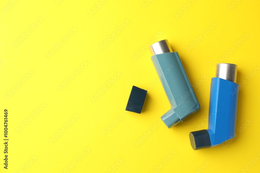 Asthma inhaler on yellow background, top view. Space for text Asthma inhaler on yellow background, top view. Space for text