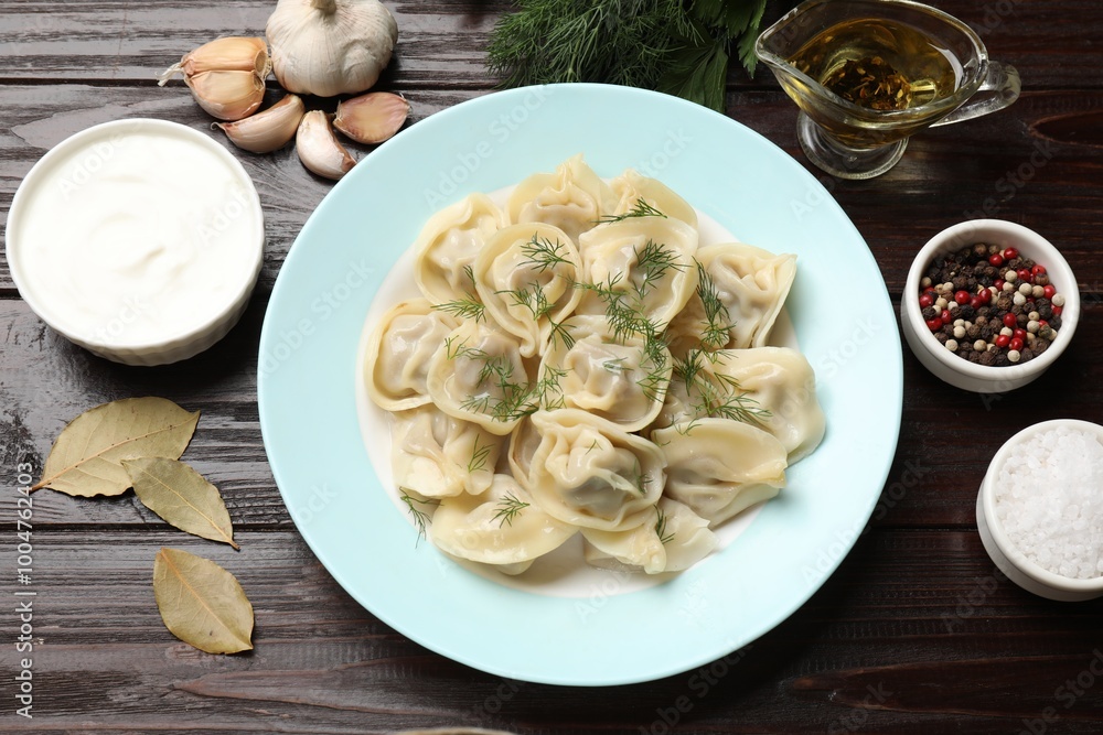 Delicious pelmeni with dill served on wooden table, flat lay Delicious pelmeni with dill served on wooden table, flat lay