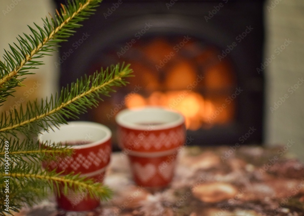 Two small cups of mulled wine by the fireplace. Warmth in the house. Two small cups of mulled wine by the fireplace. Warmth in the house.