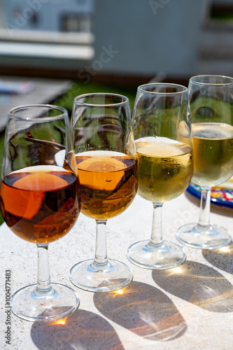 Sherry fino, manzanilla, cream wine tasting on roof of old Triana district in Sevilla with view on Sevilla houses and churches, wine glasses