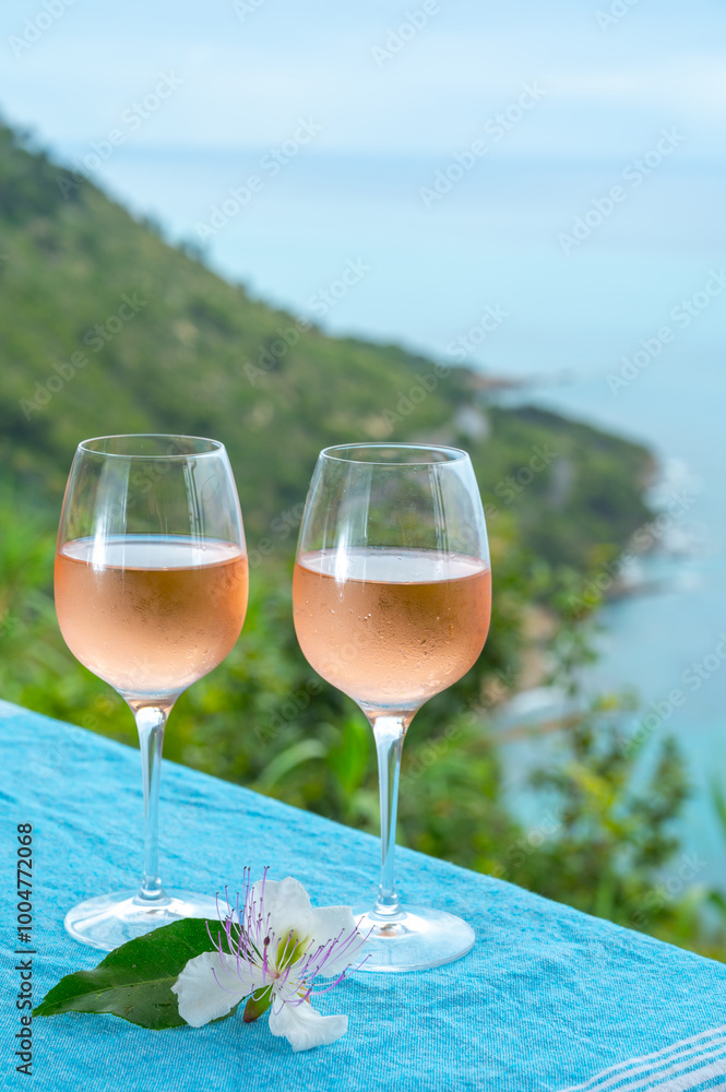Summer time in Provence, two glasses of cold rose wine with blue sea view on background, French Riviera near Menton, south of France Summer time in Provence, two glasses of cold rose wine with blue sea view on background, French Riviera near Menton, south of France