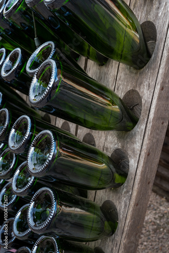 Visit of old champagne grower and producent in grand cru small village Ambonnay, Champagne, France. Empty champagne bottles on pupitre riddling racks photo