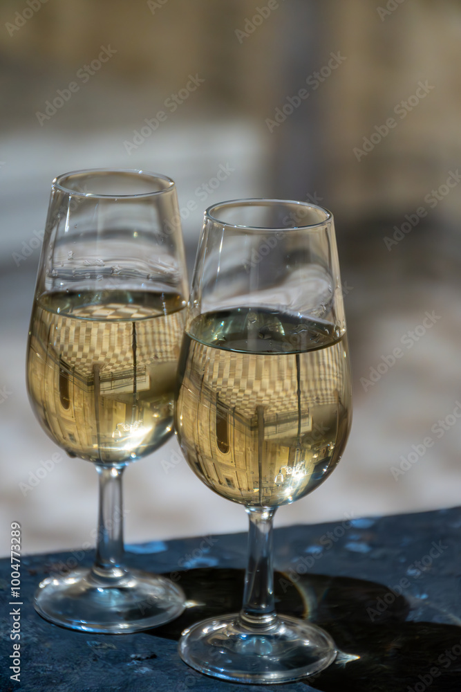 Sherry wine glasses with fino and old church on background at night in Jerez de la Frontera, wine glasses outdoor, cityview, Andalusia, Spain Sherry wine glasses with fino and old church on background at night in Jerez de la Frontera, wine glasses outdoor, cityview, Andalusia, Spain