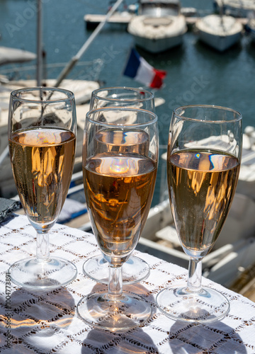 Summer party, French brut rose champagne sparkling wine in flute glasses in yacht harbour of Port Grimaud near Saint-Tropez, French Riviera vacation, Var, France photo