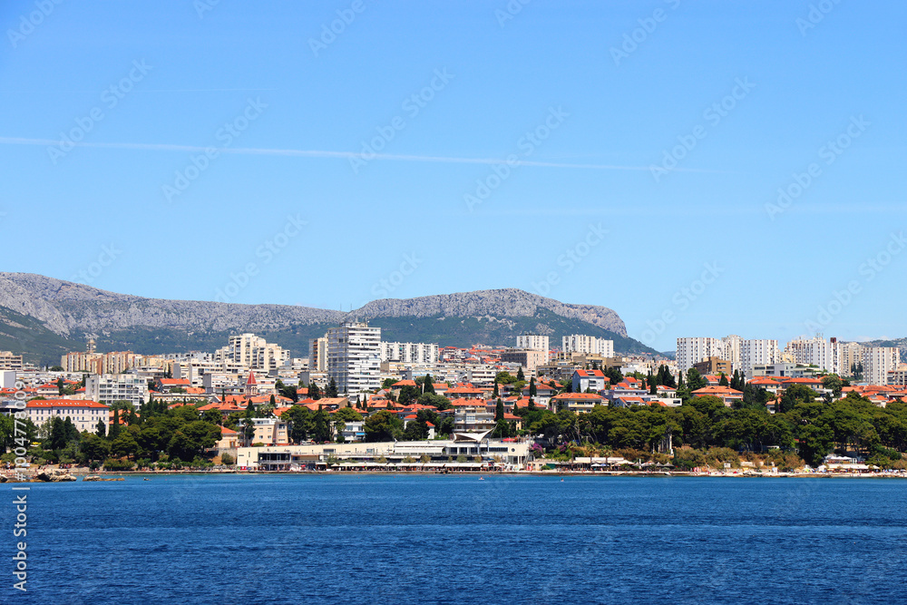 Fototapeta premium Contemporary buildings, gardens and beaches at the waterfront in Split, Croatia. View of Split from the boat.