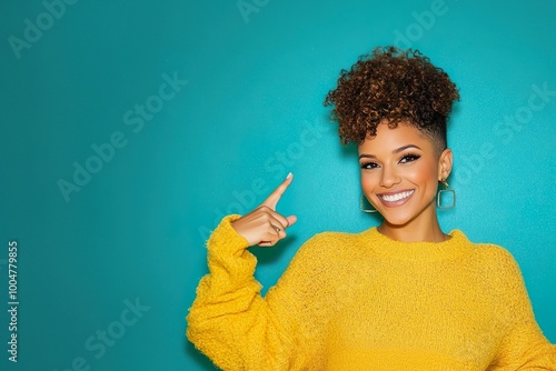 Woman in yellow sweater smiling and pointing