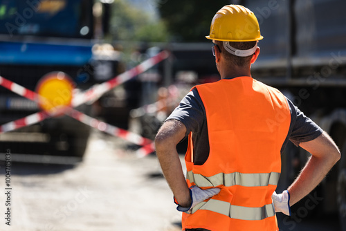 Tablou pe pânză Construction worker observing roadwork barriers during daylight hours while over