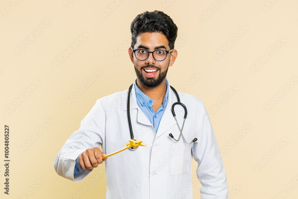 Magician wizard Indian young doctor cardiologist man with magic wand making wish come true, casting magician spell, health cure treatment help. Arabian apothecary pharmacy guy on beige background Magician wizard Indian young doctor cardiologist man with magic wand making wish come true, casting magician spell, health cure treatment help. Arabian apothecary pharmacy guy on beige background