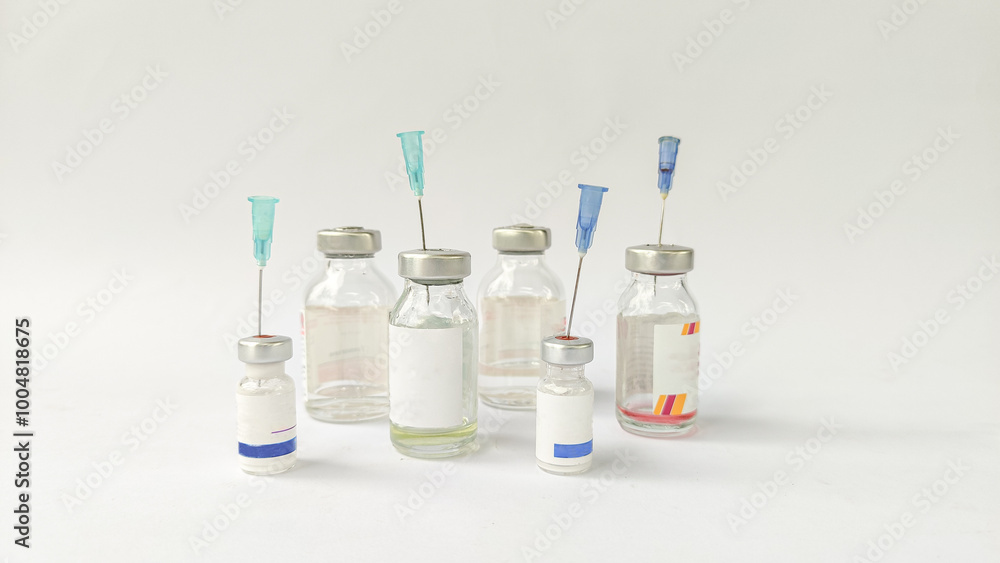 Vial of Drug or Vaccine and 3 ml Plastic Syringe with Needle Isolated on the White Background, blue tone color Vial of Drug or Vaccine and 3 ml Plastic Syringe with Needle Isolated on the White Background, blue tone color