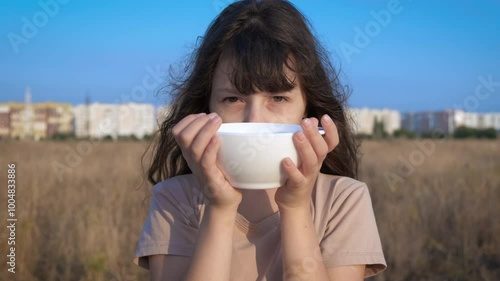 Child with starvation problem outdoor. A little girl suffer from starvetion problems during economical crissis in the world. photo