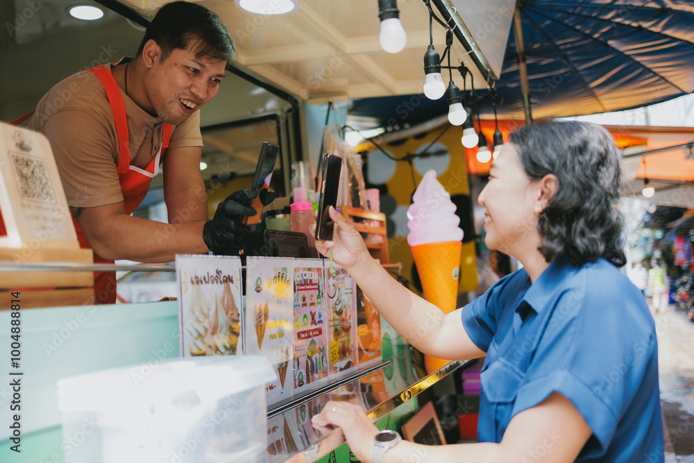 Woman Making Contactless Payment at Food Truck in Bustling Market Woman Making Contactless Payment at Food Truck in Bustling Market