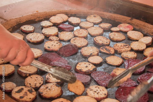 cocinando betabel en comal de leña photo