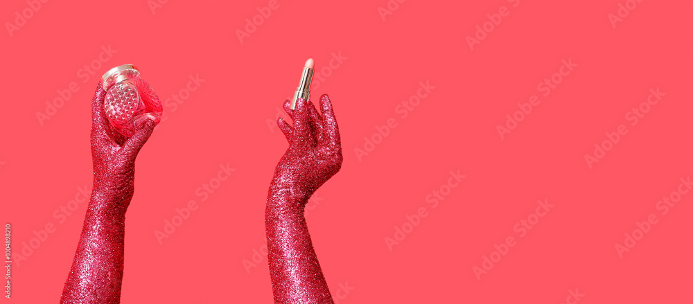Female hands covered with glitter holding perfumes and lipstick on red background with space for text Female hands covered with glitter holding perfumes and lipstick on red background with space for text
