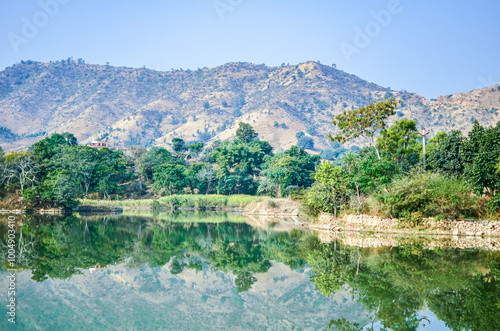 Scenic view of a freshwater rivulet winding through rocky terrain on way from Udaipur to Kumbalgarh Fort, Rajasthan, India photo