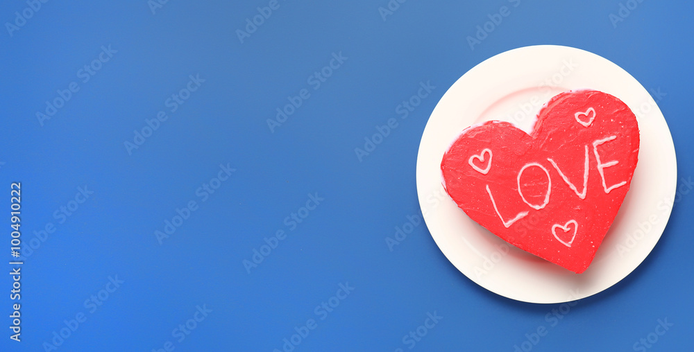 Plate with tasty heart-shaped bento cake for Valentine's Day on blue background with space for text Plate with tasty heart-shaped bento cake for Valentine's Day on blue background with space for text