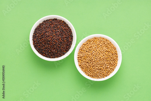 Yellow mustard seeds in two bowls. Healthy food. photo