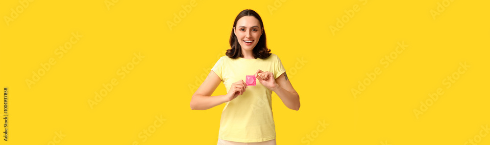 Beautiful young woman with condom on yellow background. Safe sex concept Beautiful young woman with condom on yellow background. Safe sex concept