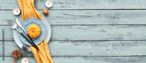 Wallpaper Mural Autumn table setting with pumpkin, dried flower and burning candles on blue wooden background Torontodigital.ca