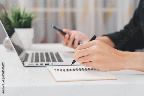 Male hand taking notes on the notepad. businessman working at work table, checklist writing planning investigate enthusiastic concept. focus on man hand holding pen, putting signature at official pape