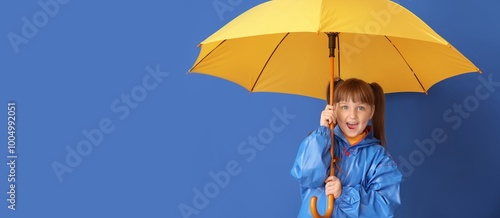 Cute little girl in raincoa...
