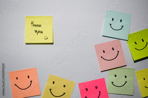 Thank you and smile emoticon on sticky notes. Motivational for personal development, inspirational handwriting. Isolated background