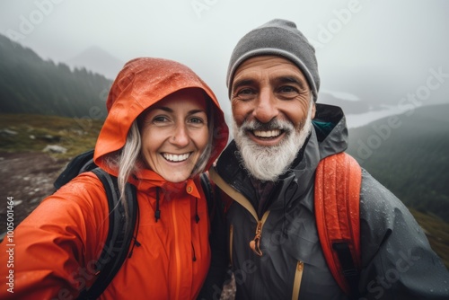 Smiling portrait of senior hikers taking selfie while hiking