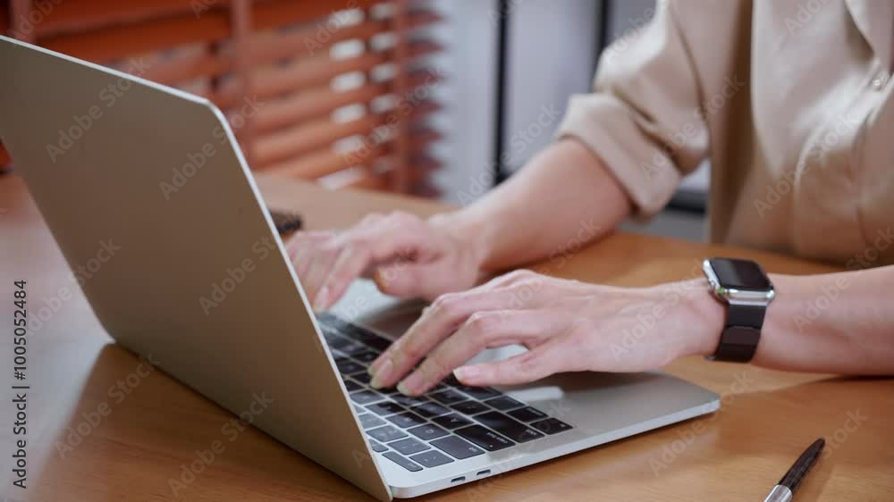 Closeup hand businesswoman using laptop computer on desk in living room at home office, business woman using laptop for surfing internet, entrepreneur or freelance, business and communication. Closeup hand businesswoman using laptop computer on desk in living room at home office, business woman using laptop for surfing internet, entrepreneur or freelance, business and communication.