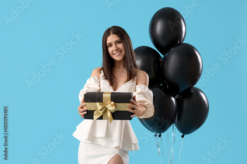Young woman with gift and b...