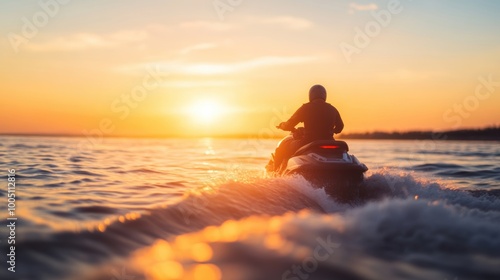 A rider on a jetski navigates the ocean waves as the sun sets, creating a stunning backdrop of colors on the water