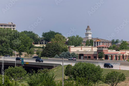 Overland Park, Kansas, USA - June 17, 2023: Morning traffic passes through the downtown commercial district of Overland Park. photo