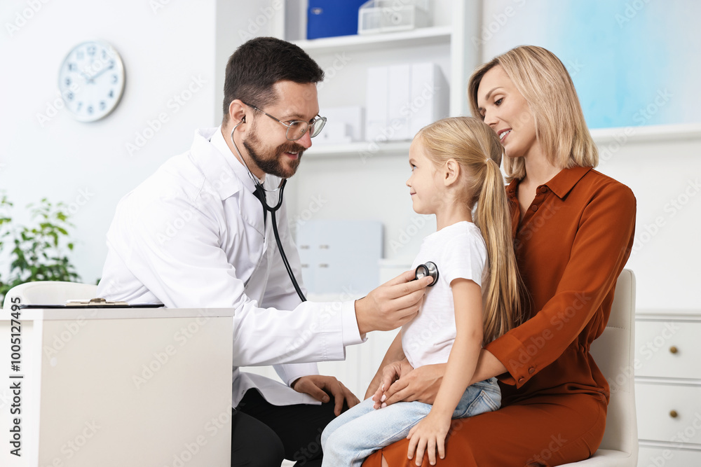 Fototapeta premium Doctor examining little girl with stethoscope and her mother in hospital