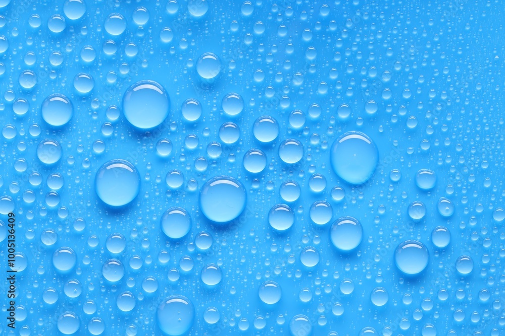 Water drops on blue background, top view Water drops on blue background, top view