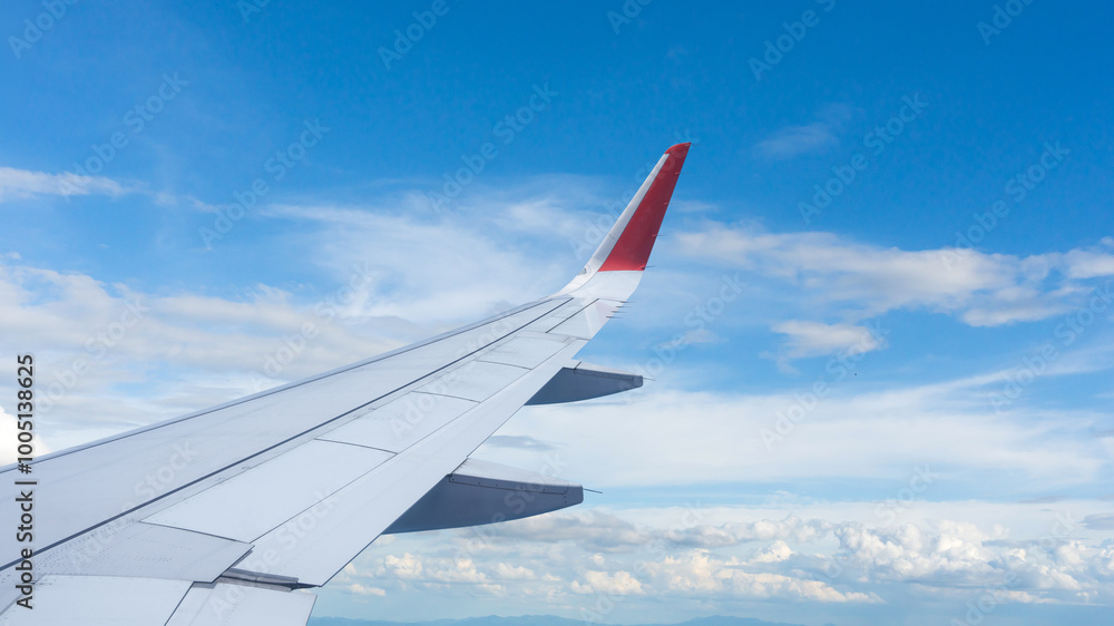 Airplane wing flying above the sky with white clouds. View from aircraft window. flying and traveling concept. Airplane wing flying above the sky with white clouds. View from aircraft window. flying and traveling concept.
