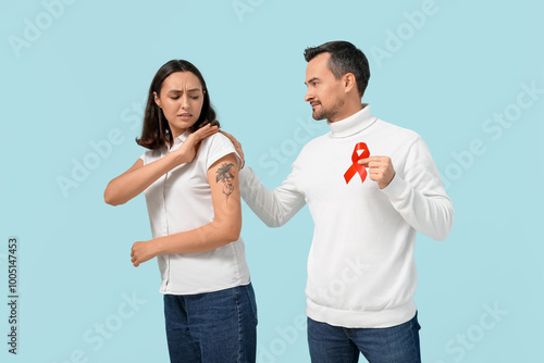 People with red ribbon on b...
